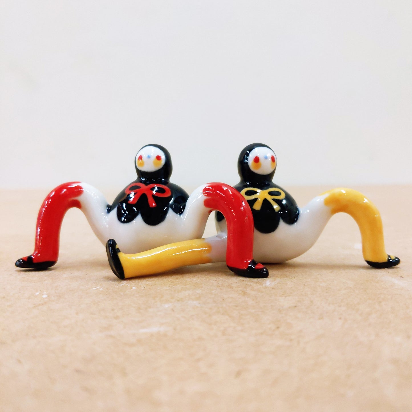 Tinybirdman Ceramic Art Toy Duo [22.053 and 22.054: Black Capelet with Bow, Red and Yellow]